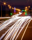 Traces of headlights from cars moving at night on the bridge, illuminated by lanterns. Abstract city landscape with highway Royalty Free Stock Photo