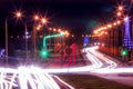 Traces of headlights from cars moving at night on the bridge, illuminated by lanterns. Abstract city landscape with highway Royalty Free Stock Photo