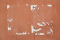 Traces of old announcements on terracotta wall. Background texture Royalty Free Stock Photo