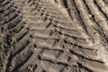 Traces of a tractor or other large machinery on the soil in the field Royalty Free Stock Photo