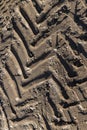 Traces of a tractor or other large machinery on the soil in the field Royalty Free Stock Photo