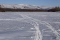 Traces of a vehicle in the snow.