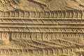 Traces of wheel tread on a sand beach Royalty Free Stock Photo