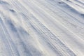 Traces of the wheels of the car on the snow-covered road Royalty Free Stock Photo