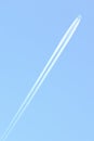 Traces and white streaks from the jet engines in the plane, white stripes in the sky. Royalty Free Stock Photo