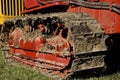 Track of a bulldozer caked with mud