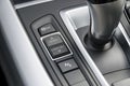 Track control buttons near automatic gear stick of a modern car, car interior details