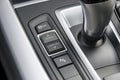 track control buttons near automatic gear stick of a modern car, car interior details.