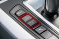 Track control buttons near automatic gear stick of a modern car, car interior details.