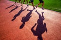 Track and Field sport athletics photo. Shadow of runners on the track