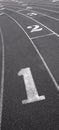 Track and Field starting running lanes on a curb with numbers Royalty Free Stock Photo