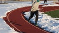 Running in winter on track with snow Royalty Free Stock Photo