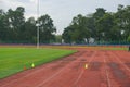 Track and fields with 2 yellow cone on track with artificial grass inside a stadium