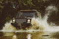 Track on mud. 4x4 Off-road suv car. Tracks on a muddy field. Jeep crashed into a puddle and picked up a spray of dirt Royalty Free Stock Photo