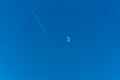 Track from the plane and the moon on a background 0f biue sky. Royalty Free Stock Photo