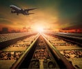 Track of railway and cargo plane flying above logistic ship port Royalty Free Stock Photo