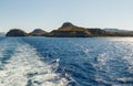 Track trail behind of speed boat on sea surface with clear sky in background