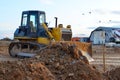 Track-type bulldozer, earth-moving equipment. Land clearing, grading, pool excavation, utility trenching, utility trenching