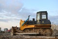 Track-type bulldozer, earth-moving equipment. Land clearing, grading, pool excavation, utility trenching, utility trenching and Royalty Free Stock Photo