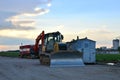 Track-type bulldozer and excavator machine for earthmoving work at construction sandpit. Royalty Free Stock Photo