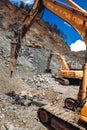 Excavator, track type bulldozer and excavator working on construction site. Ore quarry and granite ore quarry