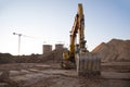 Track-type excavator during earthmoving at construction site. Backhoe digg ground at construction site for the construction