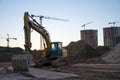 Track-type excavator during earthmoving at construction site. Backhoe digg ground at construction site for the construction