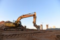 Track-type excavator during earthmoving at construction site. Backhoe digg ground at construction site