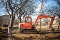 Track-type excavator loader, backhoe working on earth and loading at house construction site Royalty Free Stock Photo