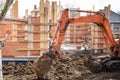 Track-type excavator loader working and loading at house construction site Royalty Free Stock Photo