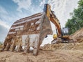 Track type loader is mining stones in opencast mining quarry. Heavy machinery