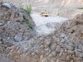 Track type loader is mining stones in opencast mining quarry
