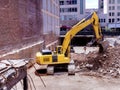 Construction backhoe clearing a basement pit