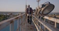 Engineer walking on a cellular tower