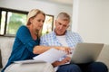 Tracking their domestic finances. a mature couple going through their paperwork together at home. Royalty Free Stock Photo