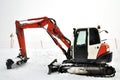 Tracklaying excavator at top of snow mountain Royalty Free Stock Photo