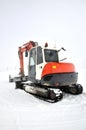 Tracklaying excavator at top of snow mountain Royalty Free Stock Photo