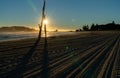 Tracks from beach grooming leading away towards sunrise Royalty Free Stock Photo