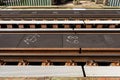 Tracks on the railway bridge over the river, visible fixing screws and metal sleepers.