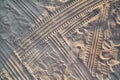 Tracks in sand. Part of prints and tracks of tire, foot, feet, sun sea slippers in beach sand. Royalty Free Stock Photo