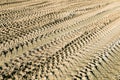 Tracks on the sand from the wheels and tracks of a tank, tractor, machine Royalty Free Stock Photo