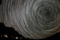 Tracks of stars in the night sky over the Caucasus mountains. Royalty Free Stock Photo