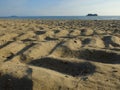 Tracks of tank wheels on sandy beach