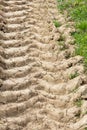 Tracks of a tractor in the ground on a dry meadow Royalty Free Stock Photo