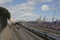 Tracks of Santa Apolonia railway station with cranes and containers in the port of Lisbon Royalty Free Stock Photo