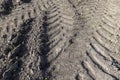 tracks from the tread of trucks and tractors on the field