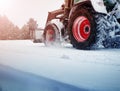 Tracktor cleaning on winter road covered with snow Royalty Free Stock Photo