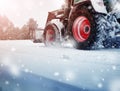 Tracktor cleaning on winter road covered with snow Royalty Free Stock Photo