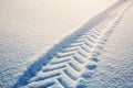 Tracktor tires on winter road covered with snow Royalty Free Stock Photo