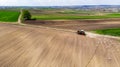 Tracktor Working in Fields at Countryside Farm. Aerial Drone View